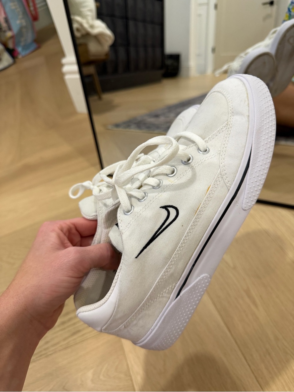 Nike Women’s White Canvas Sneakers with Black Swoosh